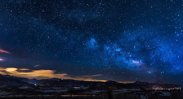 Nighttime Image of Mountains with Space and Stars